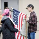 Sequim resident Sally Franz talks with Sequim High School sophomore Carson Holt at a gun control demonstration on March 14.