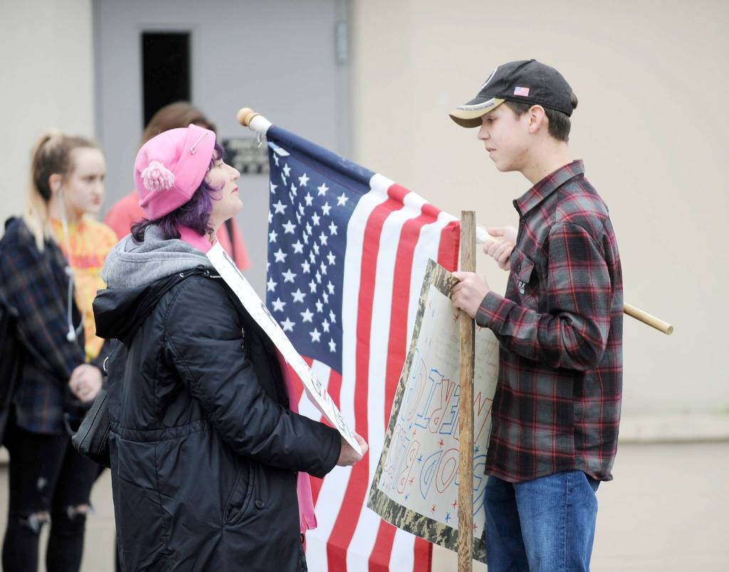 Sequim resident Sally Franz talks with Sequim High School sophomore Carson Holt at a gun control demonstration on March 14.
