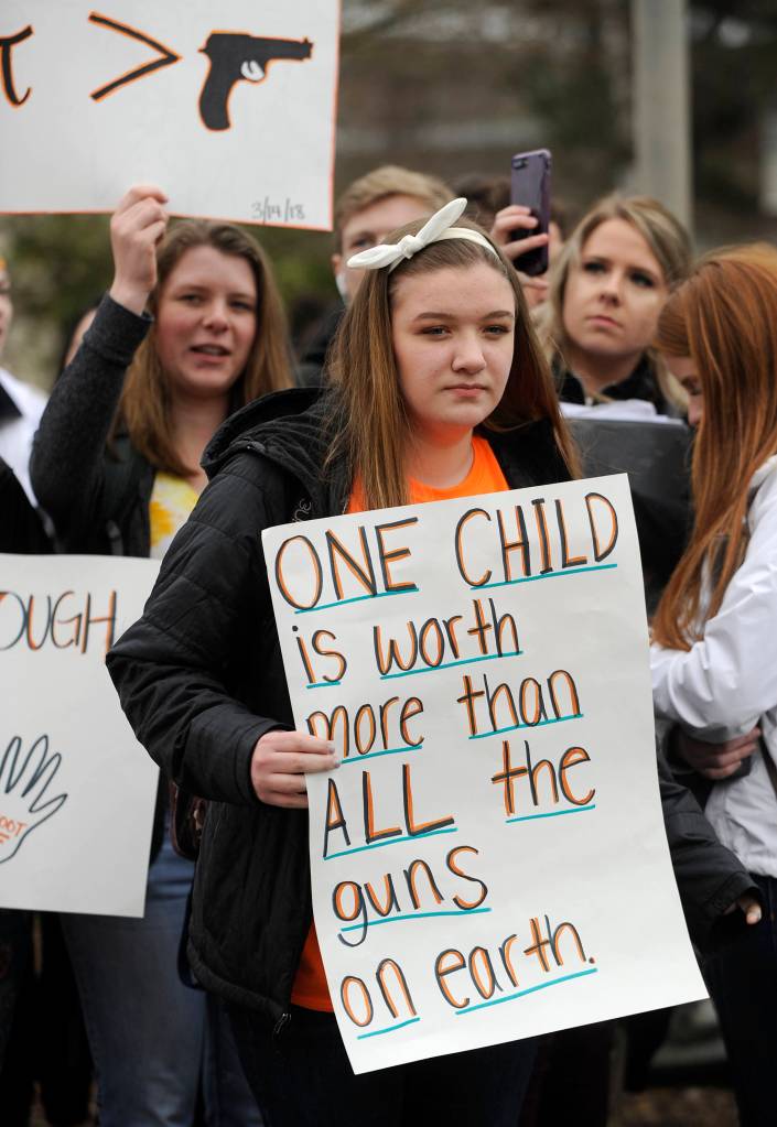 Astrid Martin (in back) and Payton Sturm holds signs at a student demonstration about gun control on March 14. Sequim Gazette photo by Michael Dashiell