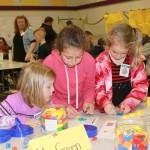 Students Xillion Stone, Rhyen Badasha and Lyra Reuther try their hand at math games at Greywolf Elementary Schools Math Night on March 22.