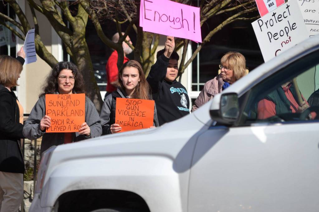 Laura Fierro and her daughter Wren Fierro, 15, stand near Dylan Jackson, 14, and his grandmother Loretta Vlaardingerbroek advocating for stricter gun control on March 24 as part of the March for Our Lives rally. Both the Sequim students participated in the National Walkout on March 14 too, they said. Sequim Gazette photos by Matthew Nash