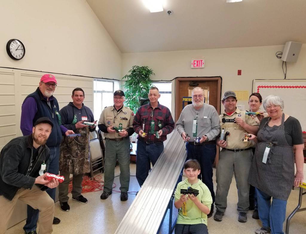 Drivers at the Pinewood Classic Adult Pinewood Derby on March 24 featured, from left, Zach Stone, Vern Ahrendes, Rick Roque, Jim Little, Brian Scott, Bruce Neilson, Mike Pinell, Amanda Pinell, Anne Mullen and Zachary Pinell, in front. Photo courtesy of Shana Scott