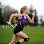 Sequims Daisy Ryan gets the Wolves off to a fast start in the 4x200 relay to kick off the Flying A Retro meet in Port Angeles on March 29. Ryan and the Wolves won the event, clocking in at 1:57.44. Sequim Gazette photo by Michael Dashiell