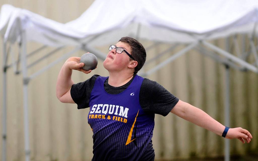 Sequims Noah Eveland throws the shot put at last weeks Flying A Retro track and field meet in Port Angeles. Sequim Gazette photo by Michael Dashiell
