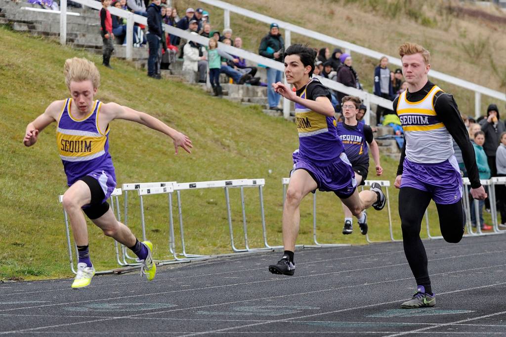 Sequim 100-meter runners (from left) Silas Isenberger, Darren Salazar, Logan Laxson and (in background) Sidney Johnston finish strong in the event at a March 29 Port Angeles meet. Isenberger won in 11.72, with Laxson second (11.83) and Salazar third (11.84). Sequim Gazette photo by Michael Dashiell