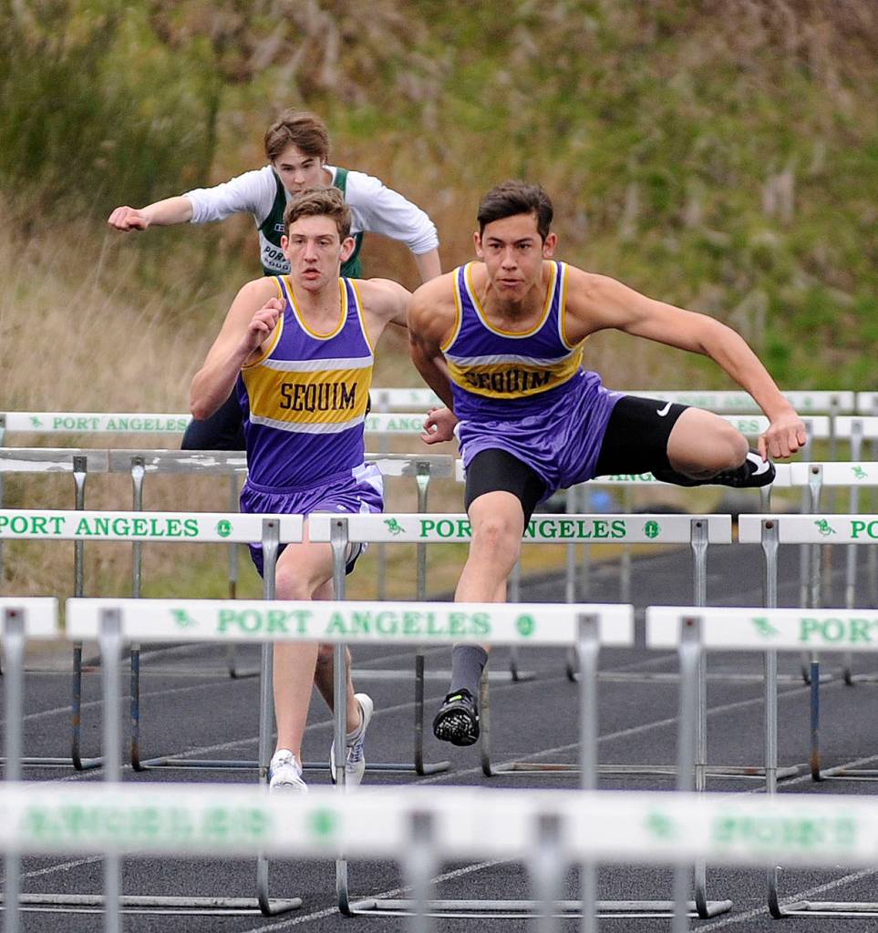 Sequims Riley Martin, right, and Fischer Jensen race to personal best marks in the 110 high hurdles last week at the Flying A Retro meet in Port Angeles. Martin finished in 15.72 seconds, Jensen in 17.14. Sequim Gazette photo by Michael Dashiell