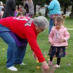 Elks Lodge member Sharon Blanken, left, helps Aria Cummings, 2, put eggs in her basket at the Elks Lodge Easter egg hunt on March 31. Sequim Gazette photo by Erin Hawkins