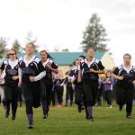 Fastpitch players ages 13 and up run on to the field during the 2017 Sequim Little League opening day ceremony.