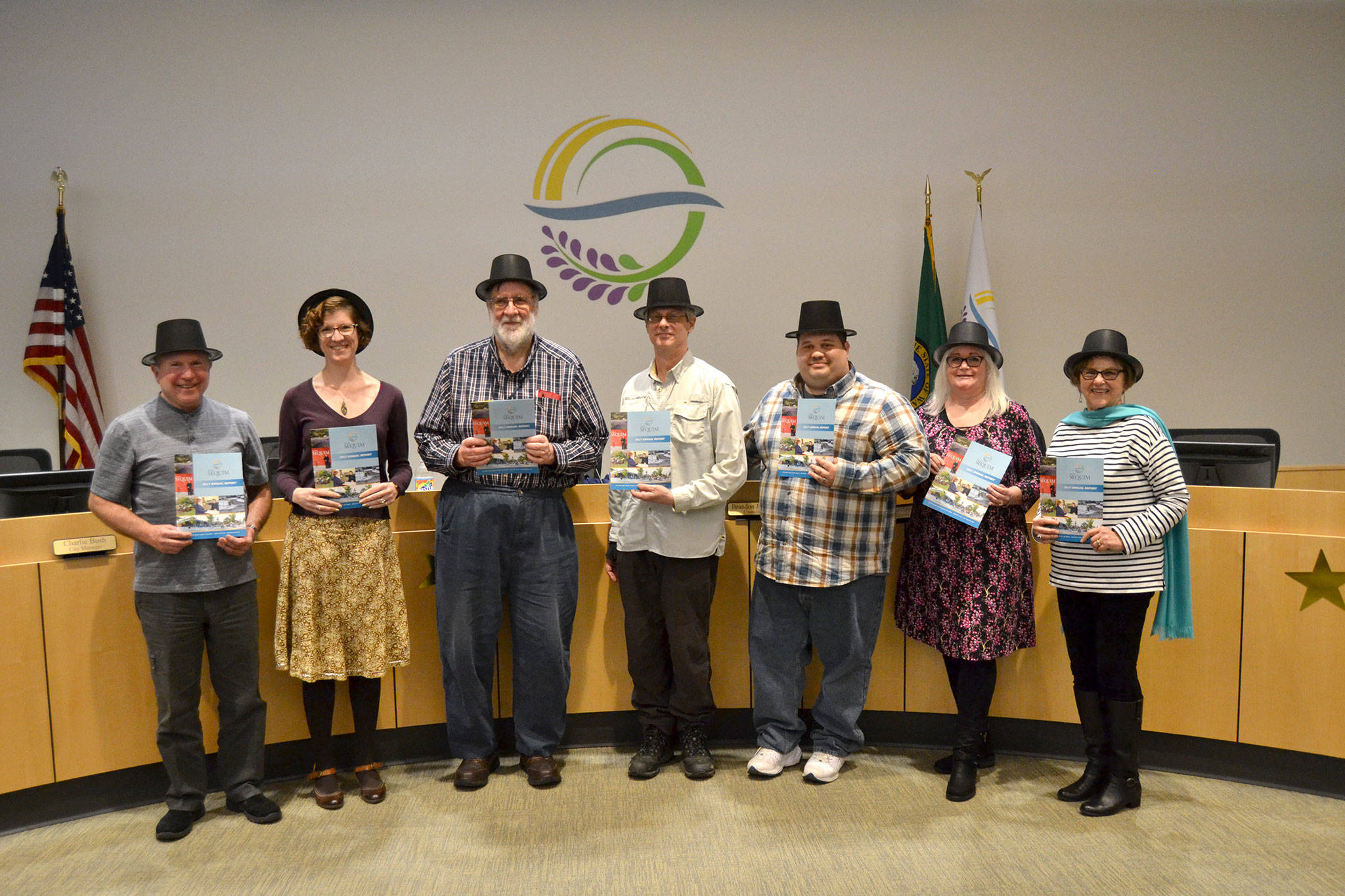 Sequim City Councilors, from left, Mayor Dennis Smith, Jennifer States, Ted Miller, Bob Lake, Brandon Janisse, Pam Leonard-Ray, and Deputy Mayor Candace Pratt stand together after a presentation on the City of Sequims 2017 Annual Report. City staff introduced city councilors similarly to starting lineups in sports and recapped last years accomplishments and projects in brief segments. Sequim Gazette photo by Matthew Nash