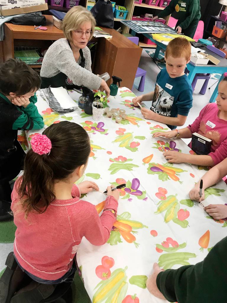 Students Arvids Prorok and Olivia Lopez getting ready to plant their seeds with help from Clallam County Master Gardener Sandra Whitney. Submitted photo
