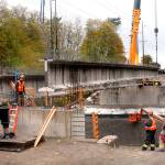 A crew from Ness Cranes of Seattle hosts the last of four 148-foot reinforced concrete beams into place in last November for the new Old Olympic Highway bridge spanning McDonald Creek. File photo by Keith Thorpe/Peninsula Daily News