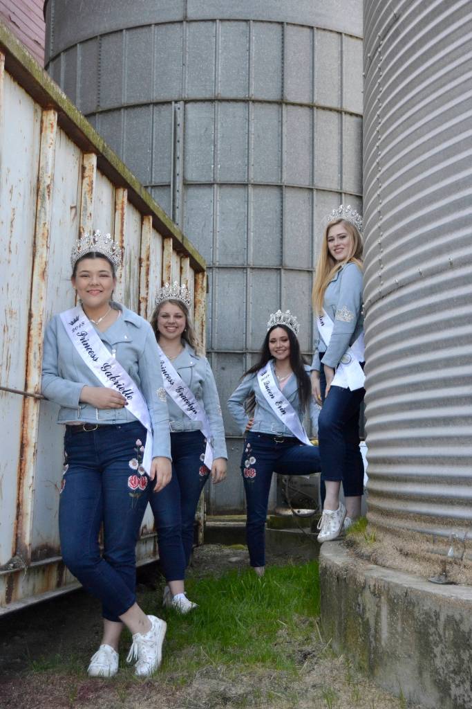 Sequim Irrigation Festival royalty, from left, Princess Gabi Simonson, Princess Gracelyn Hurdlow, Queen Erin Gordon, and Princess Eden Batson stand in the shade at the Dick Family Barn during a photo shoot for the festivals programming. Sequim Gazette photo by Matthew Nash