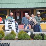 Community members gather with signs Please Please Help Save Our Marina! prior to the Sequim City Council meeting on April 23, where councilors approved a resolution to reaffirm the citys position that private marinas are not allowed. Sequim Gazette photos by Matthew Nash