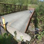 In mid-April, a portion of the Dean Creek bridge in Blyn sunk due to high water leading officials with the Jamestown SKlallam Tribe and the Peninsula Trails Coalition to close it. No timetable has been set for its repair. Sequim Gazette photo by Erin Hawkins