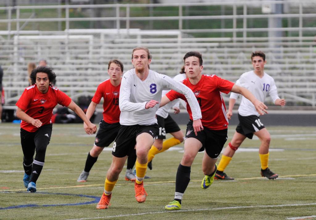 Sequims Liam Harris (8) looks for possession of a corner kick in the first of half of Sequims 6-0 district tourney win over Orting on Saturday. Sequim Gazette photo by Michael Dashiell