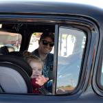 Nick Stewart and his daughter Kensington, 2 1/2, of Bonney Lake, ride as the last entry in the Hot Rods & Harleys Car Cruzz on May 12. Nick drove his dad Gary Stewarts 1957 Chevy truck while Gary drove the 1979 Chevy C10 along Washington Street to Walmart for the car show. Sequim Gazette photo by Matthew Nash