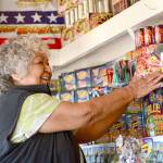 Margie Macias arranges fireworks at her fireworks stand, Margie Fireworks, on the Lower Elwha Klallam Tribe reservation in 2017. Photo by Jesse Major/Peninsula Daily News