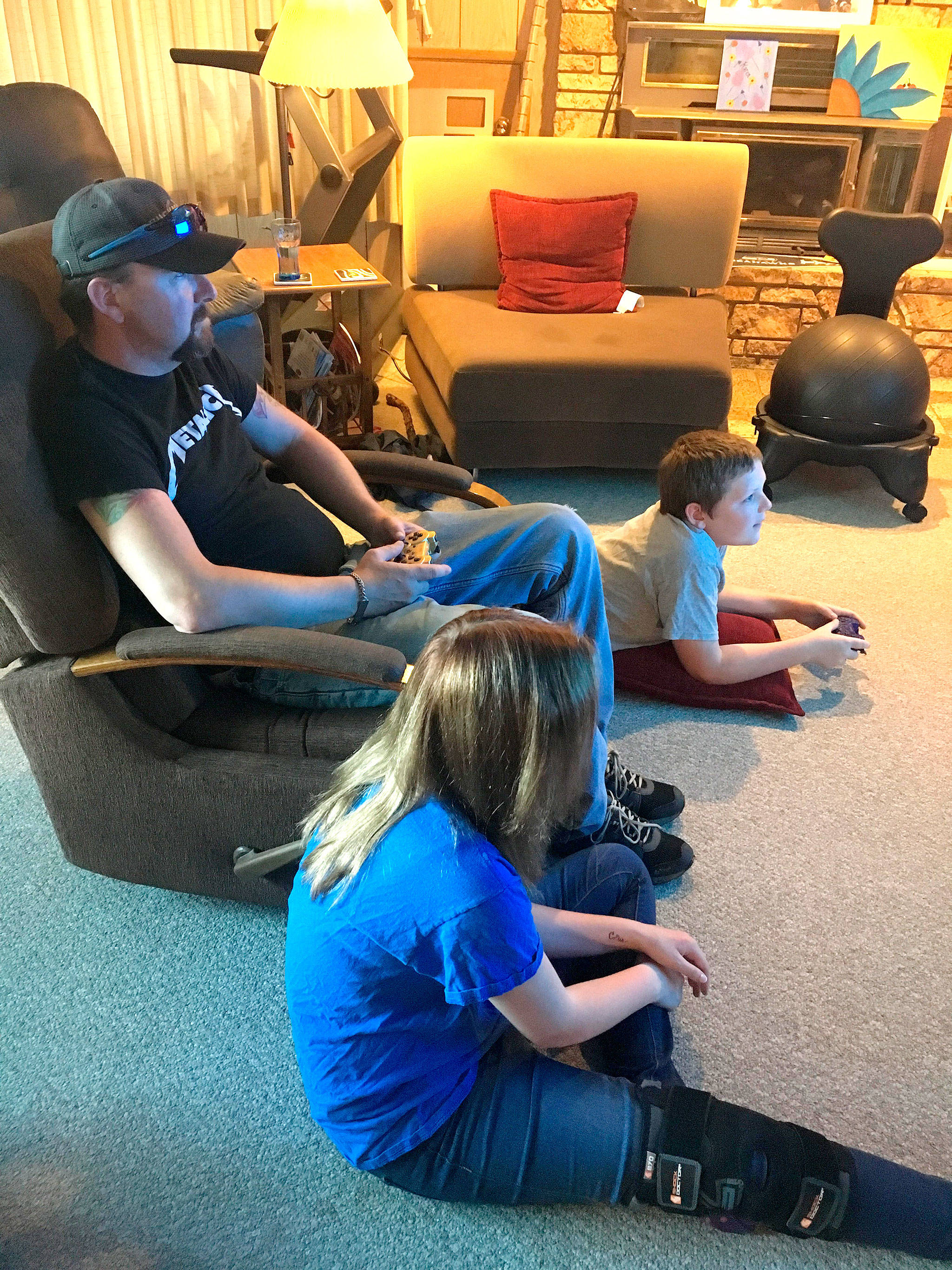 A video game tournament on June 2 at the Sequim Boys & Girls Club benefits Sean McKeown of Sequim, seen here playing video games with his children Madison and Dylan. Sean was diagnosed with multiple sclerosis in 2000 and hes sought alternative treatments after he is unable to use his medicine after 10 years. Submitted photo