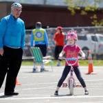 Lily Arrington considers the next skills challenge at the first Bike Rodeo in Sequim on May 5, with help from volunteer Bob Anundson.