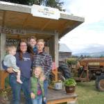 The Calf-inated Cow farm stand is one of the many in Sequim that offers fresh, local produce to passerby on a weekly basis. The farms owner Kristin Higgins, left, with youngest son Ivan, 1, William, 12, back center, husband Brian Higgins, right, and daughter Jane, 5, stand in front of their farm stand at 343 McComb Road. Sequim Gazette photo by Erin Hawkins