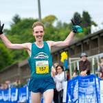 North Olympic Discovery Marathon winner Keith Laverty of Bainbridge Island celebrates as he crosses the finish line, breaking the previous record by more than one minute. (Jesse Major/Peninsula Daily News)