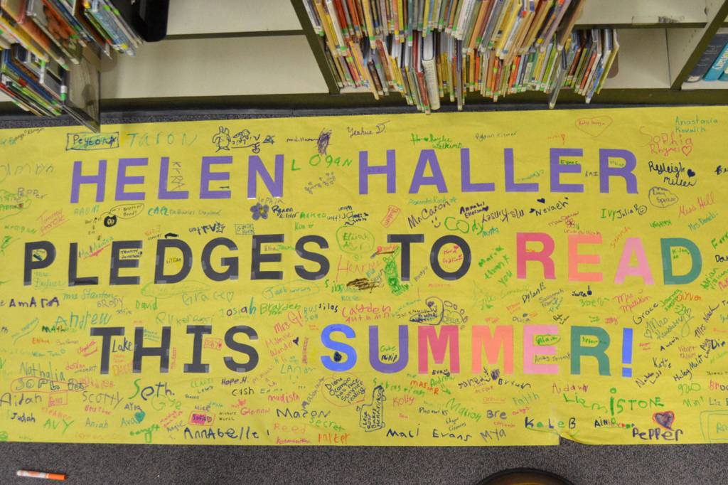 Students and staff at Helen Haller Elementary signed a banner pledging to read this summer. Sequim Gazette photo by Matthew Nash