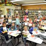 Bettina Hoesels first grade students hold up their favorite book they received through the Six Books for Summer program last week. In its second year at Helen Haller Elementary, school officials said the program helped maintain or increase reading levels in four of five participating grade levels. Sequim Gazette photos by Matthew Nash
