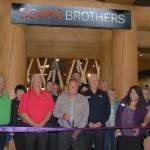 Jerry Allen, 7 Cedars Casino CEO, center, cuts the ribbon at the Casinos new restaurant The House of Seven Brothers, with food and beverage director Larry Smithson, left, and general manager Glenn Smithson, right, along with members from the Sequim-Dungeness Valley Chamber of Commerce on June 7. Sequim Gazette photo by Erin Hawkins