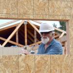 Bill Prichard of Anacortes cuts out a window on a new mower shed in Carrie Blake Community Park. Prichard and his wife are two of 20-plus Care-A-Vanners with Habit for Humanity assisting with neighborhood revitalization projects in Sequim through June 15. Sequim Gazette photos by Matthew Nash