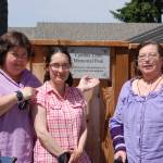 Close friends of Cynthia Little, such as Bernie Philbin, left, CASA volunteer Emma Jones and Maggie Philbin, stand next to Littles dedication plaque at the Sunland Golf & Country Club pool on June 17.