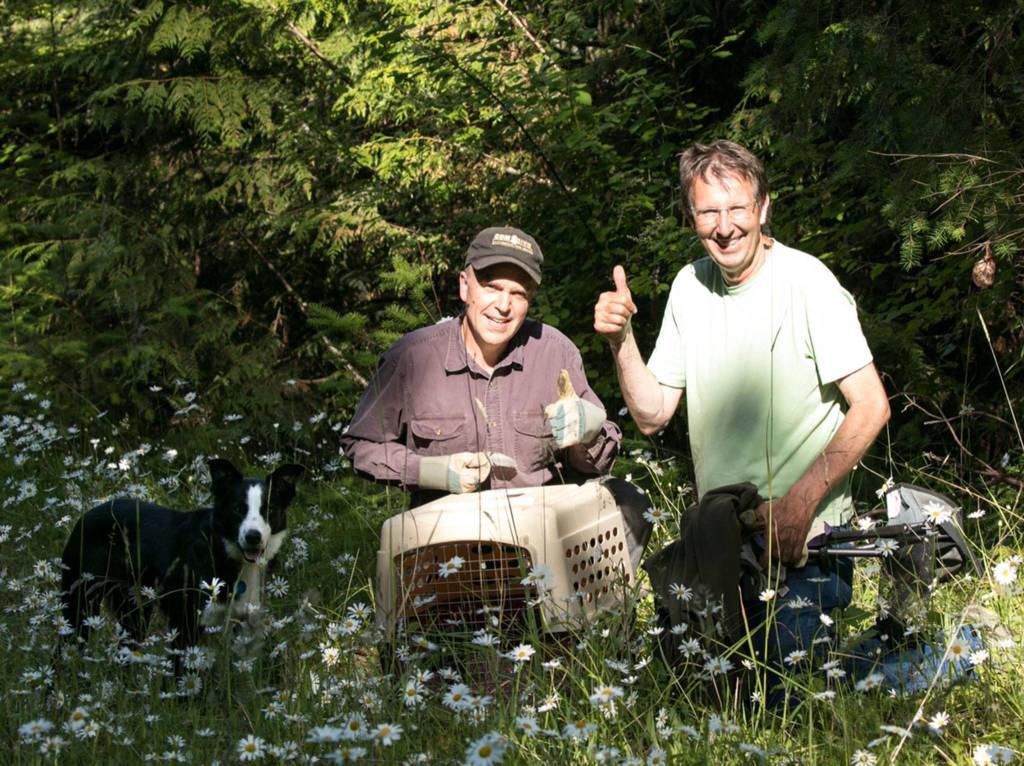 John Engstrom, Ken Kennedy and Champ the dog stand together after working together to recover Harold Heron, Jr., after falling about 75 feet. The trio along with Suzanne Anaya brought it to the Northwest Raptor & Wildlife Center where its anticipated to fully recover. Photo courtesy of Suzanne Anaya