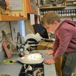 Henry Lutz, 5, of Puyallup looks into a microscope on June 22 inside the Dungeness River Audubon Center during a family trip to the Olympic Peninsula. Last year, the center hosted 8,000 people and now volunteers seek $1.7 million to finish a campaign to expand the center.