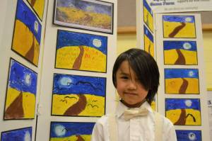 Mason Blake, 6, says his favorite piece follows Vincent Van Goghs style. Mason and about 20 other kindergarteners stayed after school with his teacher Stephanie Grotzke-Nash for five weeks making art in the style of different artists. Sequim Gazette photo by Matthew Nash
