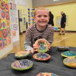 Taylor Thomas, 7, a second grader in Renee Mullikin and Kaylee Kinseys art class, holds his bowl he made for the art show. He said it was the most fun of all the projects to make.