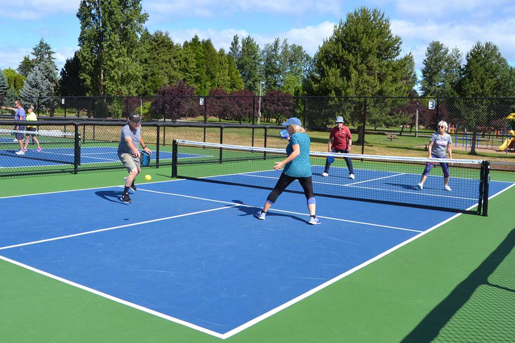 Pickleball players, from left, Ken Sorbel, Glynda Ball, John Anderson and Margie Rone enjoy a game on July 2 on the new pickleball courts in Carrie Blake Community Park. Sequim Gazette photo by Matthew Nash