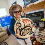 Elaine Grinnell, a prominent Jamestown SKlallam storyteller, basketmaker and drum maker, holds one of her drums in her living room Tuesday. She recently earned the 2018 Community Spirit Award from the First Peoples Fund. (Jesse Major/Peninsula Daily News)