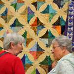 Last years featured artist Murph Gerber, left, talks about her technique with Trudie Holt of Bremerton at the Sunbonnet Sue Quilt Clubs annual show in 2017. This years show returns to the school July 20-22. Sequim Gazette file photo by Matthew Nash