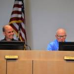 Joe Irvin, Sequim assistant city manager, smiles as Mayor Dennis Smith reads a resolution on July 23 recognizing Irvin for his service with the city. Irvins last day was July 24 before taking a job in California. Sequim Gazette photo by Matthew Nash