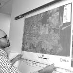 Sequim Assistant City Manager Joe Irvin holds maps of different regions in the City of Sequim in 2017 prior to a Neighborhood Visioning Meeting. Irvin plans to leave the city to work in Healdsburg, Calif. Sequim Gazette photo by Matthew Nash