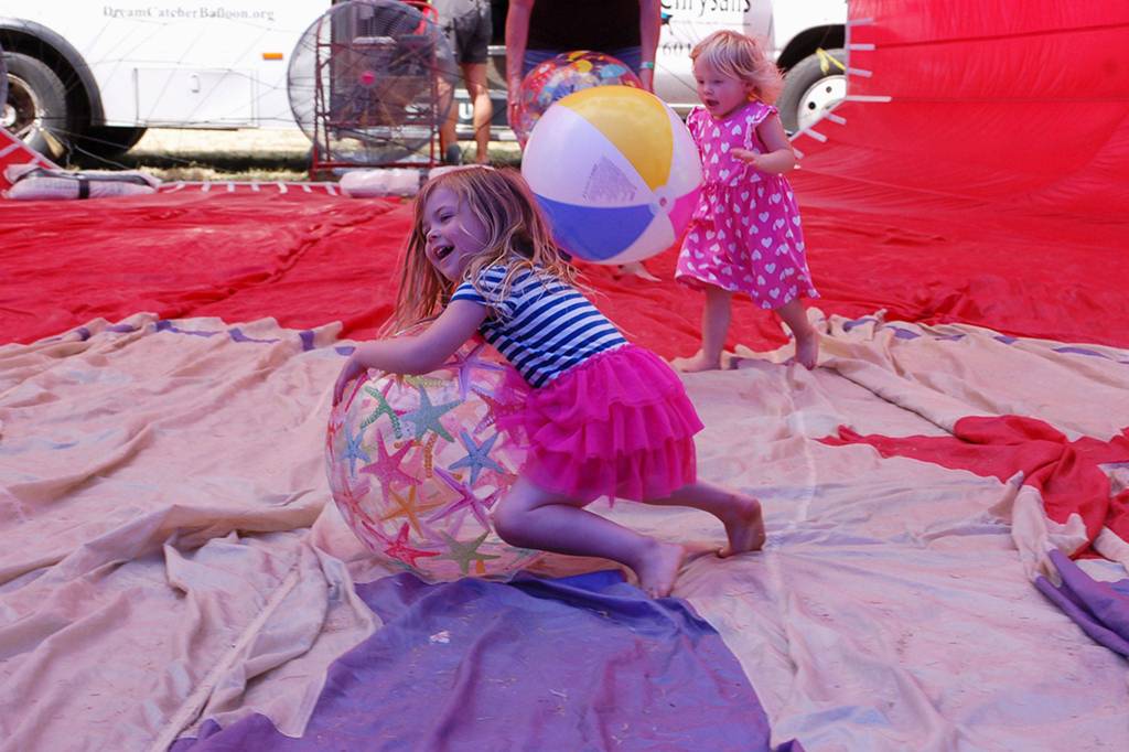 Sisters Goldie and Maisy Weeks from Poulsbo play with beach balls in one of Dream Cather Balloons at Olympic Lavender Heritage Farm during Sequim Lavender Weekend.