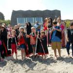 Members of the Lower Elwha Klallam tribe sing a welcome song to an arriving canoe on Hollywood Beach on July 20. Photo by Keith Thorpe/Peninsula Daily News