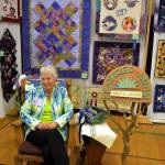 Loretta Bilow, featured quilter of the Sunbonnet Sue Quilt Clubs annual show, speaks with visitors on July 21.