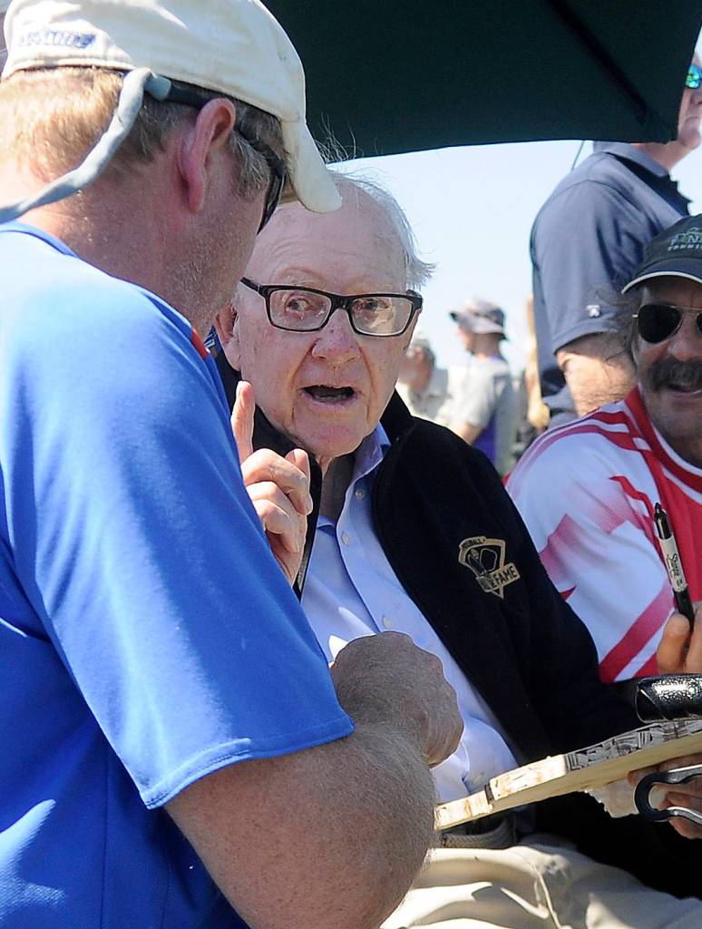 Barney McCallum, co-creator of the sport of pickleball, signs a racket and talks with Kendal Wake of Sequim at last weeks ribbon-cutting ceremony.