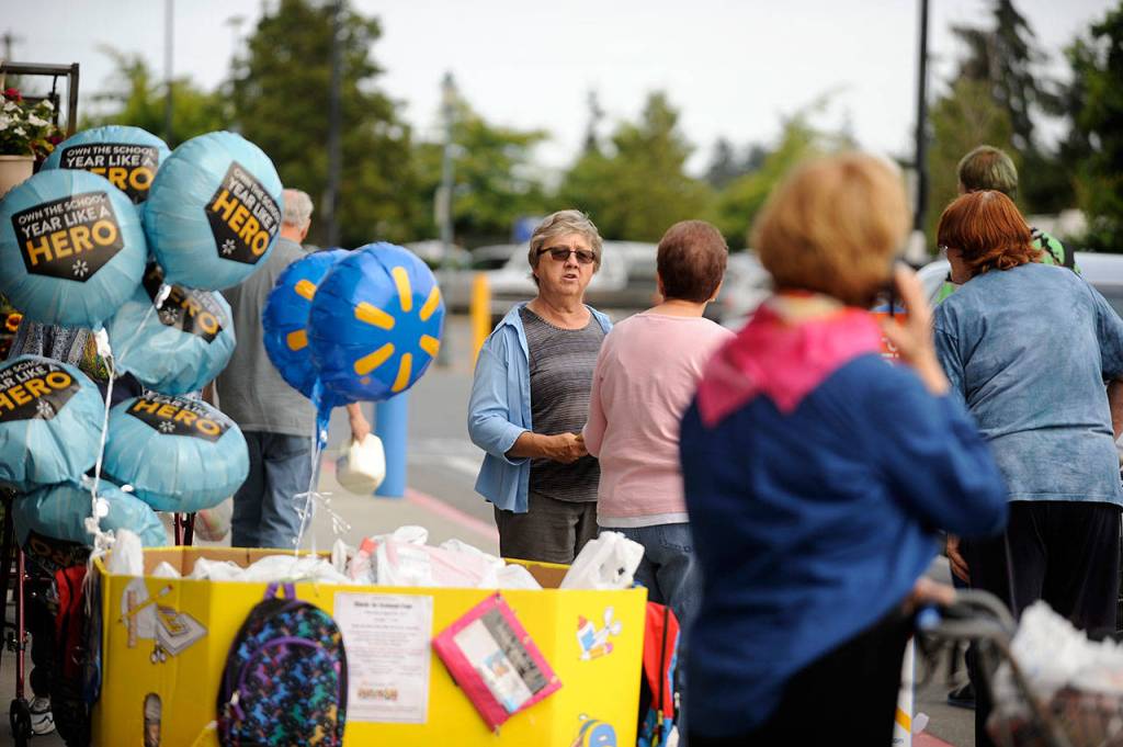 Philomena Lund talks with customers outside the Sequim Walmart during the annual Stuff the Bus event in 2017. Sequim Gazette file photo by Michael Dashiell
