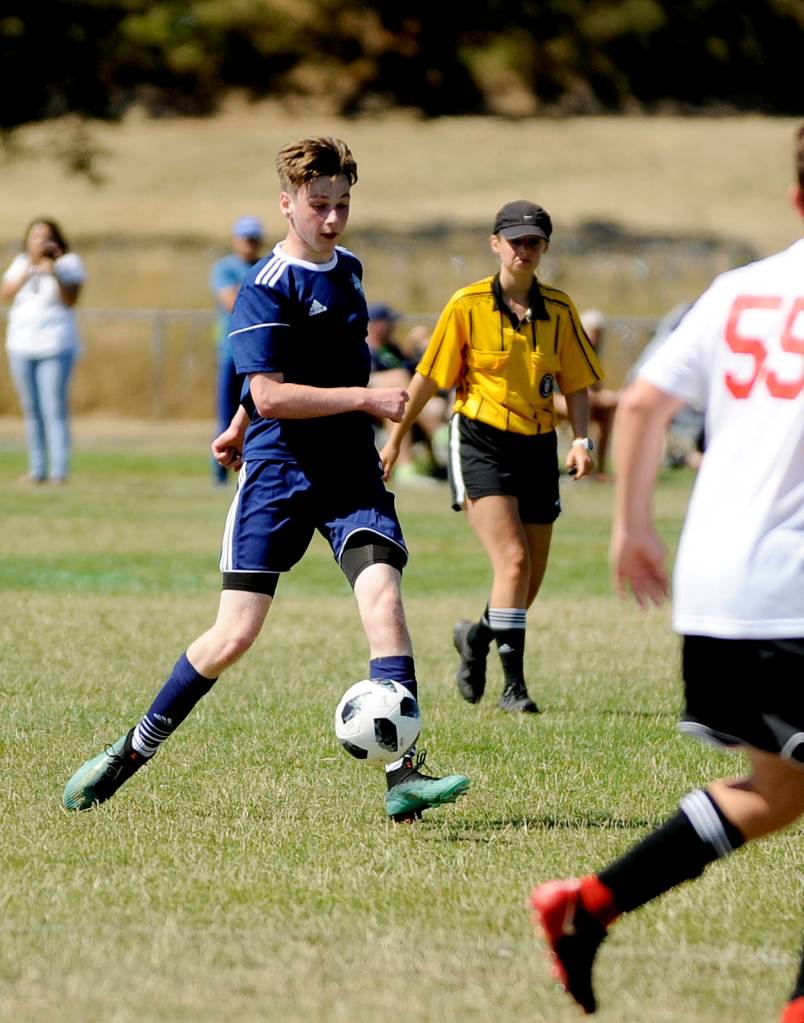 Porter Little and Storm King BU16 takes on the Nortac Sparta B03 squad at last weekends Dungeness Cup. Sequim Gazette photo by Michael Dashiell