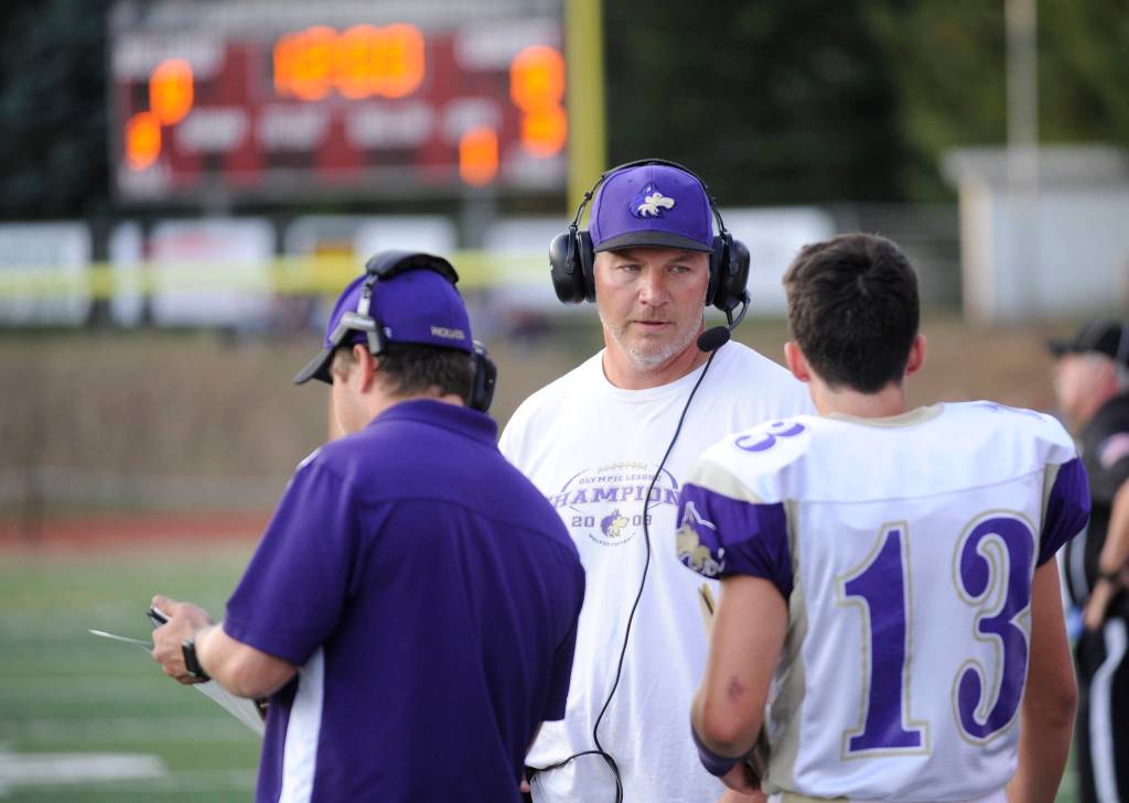 Sequim head coach Erik Wiker looks to a crop of young players to help fill key skill positions, including his sophomore son Taig (right). Sequim Gazette file photo by Michael Dashiell