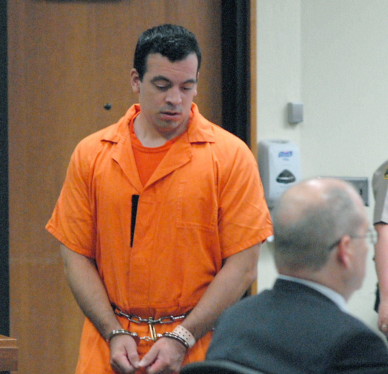Nathan A. Chavez of Sequim enters Clallam County Superior Court to sit with attorney Stanley Myers, right, during Chavez sentencing on Thursday after being found guilty of guilty raping two 14-year-old girls he had befriended and with tampering with a witness in his case. (Keith Thorpe/Peninsula Daily News)