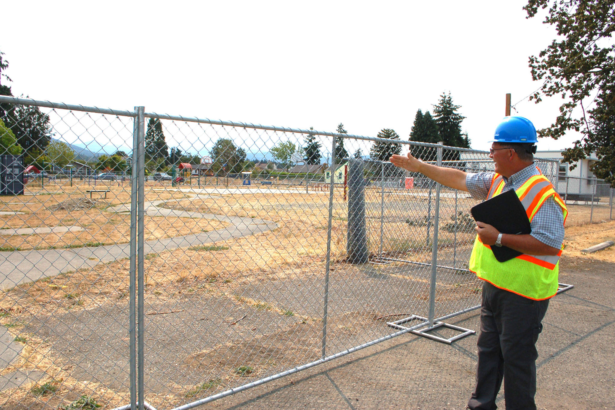 John McAndie, Sequim School Districts maintenance and operations supervisor and director of facilities, says the playground next to the Community School on West Fir Street and North Second Avenue is closed as the districts new central kitchen is built. Olympic Peninsula Academy parents say they have questions where their students will play at recess as students are put in portables for temporary housing while the kitchen is built. Sequim Gazette photo by Erin Hawkins