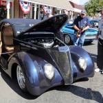 Attendees at the Sequim Prairie Nights car show last year look at Steve Pillows 1937 Ford coupe that took Peoples Choice. This years show features more than a dozen trophies. Sequim Gazette file photo by Michael Dashiell