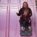 Michele Billings of Port Angeles and her daughter Isabella, 2, ride together down the giant slide at the Clallam County Fair on Aug. 17.